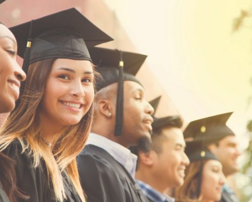 Graduation_StudentsGroup_Smiling_Outdoor_GettyImages-907837926